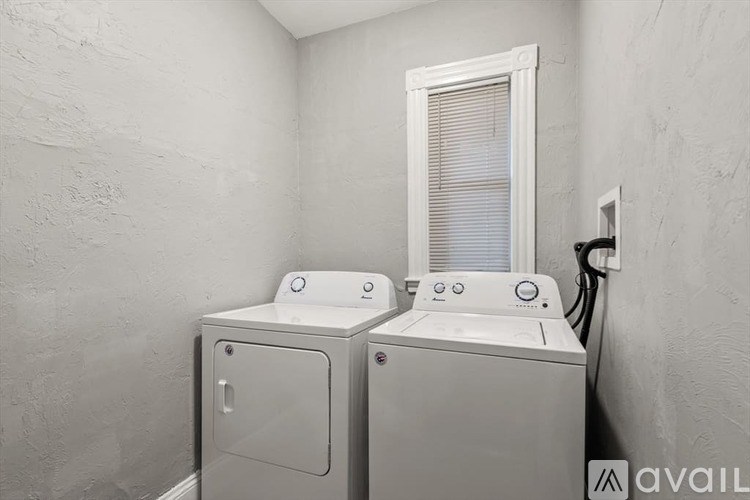 Two washing machines in a laundry room.