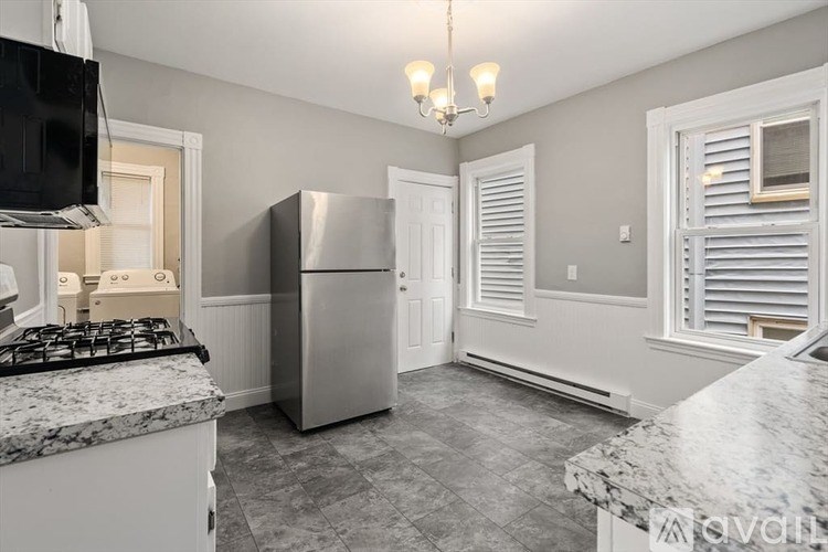 A kitchen with a stove, refrigerator, and a countertop.
