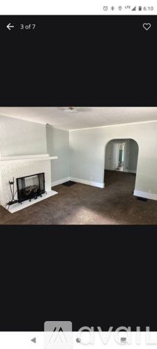 A room with a fireplace and a mirror on the wall.