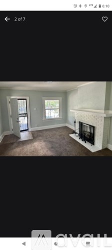 A room with a fireplace and a window.