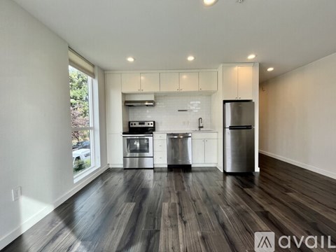A kitchen with a stainless steel refrigerator, oven, and cabinets.