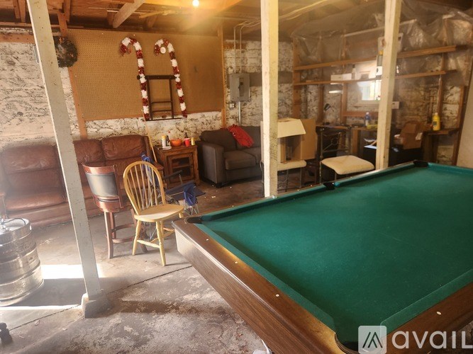 A pool table is in the foreground of this image.