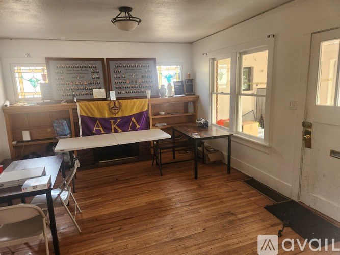 A room with a banner that says "Alpha Kappa Psi" on it.