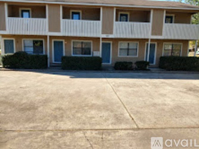 Apartment complex with blue doors and windows.