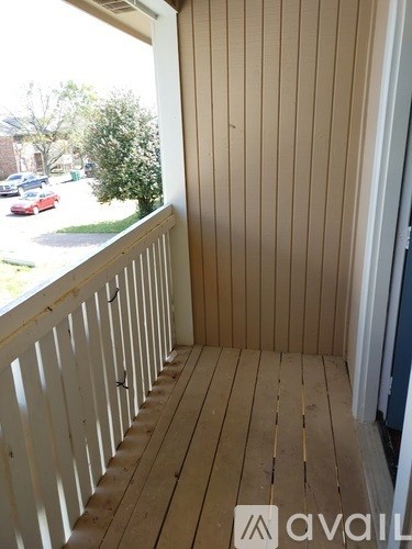 A balcony with a view of a street and cars.