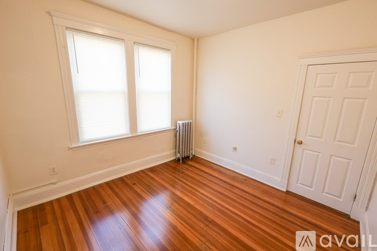 A room with wooden floors and a white door.