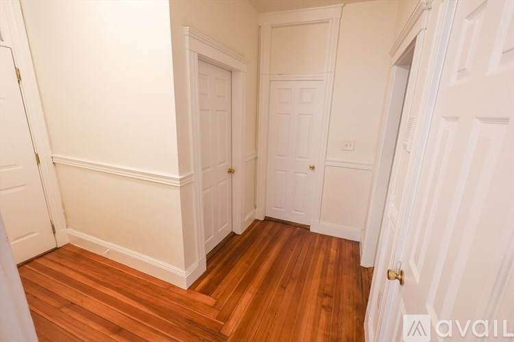 A room with wooden floors and white walls.