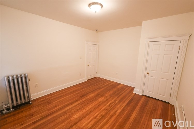 A room with wooden floors and a white door.