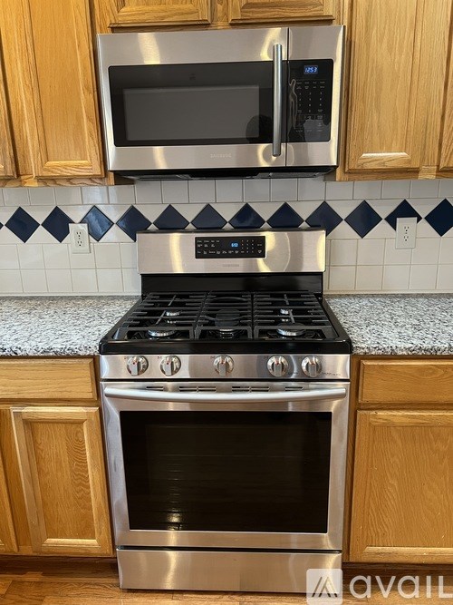 A kitchen with a stove top oven and microwave above it.