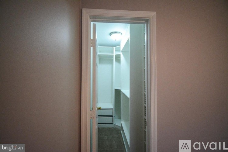 A doorway leading to a hallway with a light on.