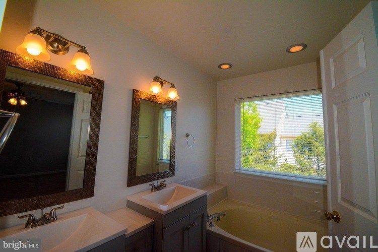 A bathroom with two sinks and a large mirror.