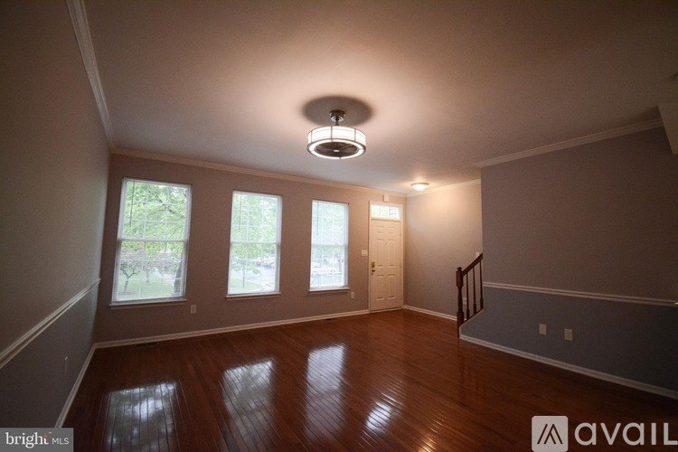 A room with wooden floors and a ceiling light.