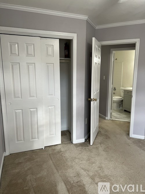 A white door is open to a bathroom.