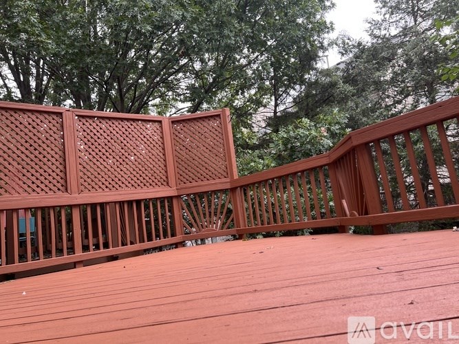 A wooden deck with a lattice design on the railing.
