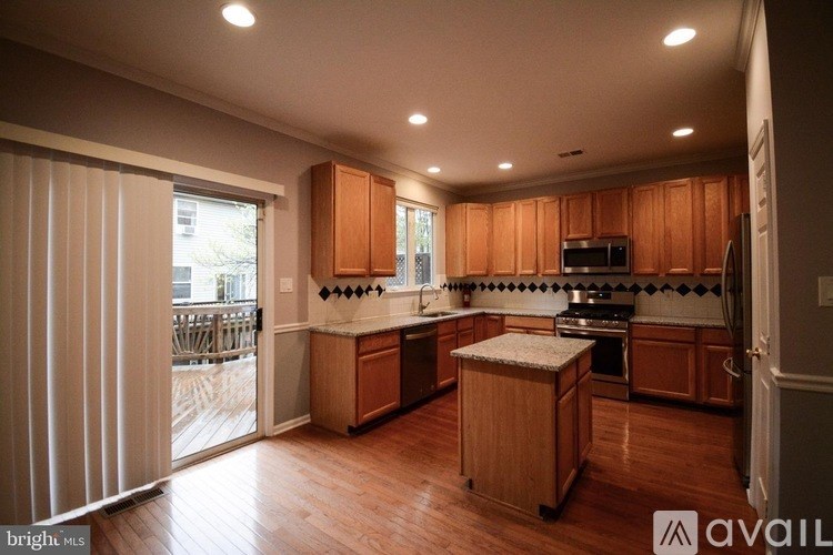 A kitchen with wooden cabinets and a countertop with a microwave and oven.