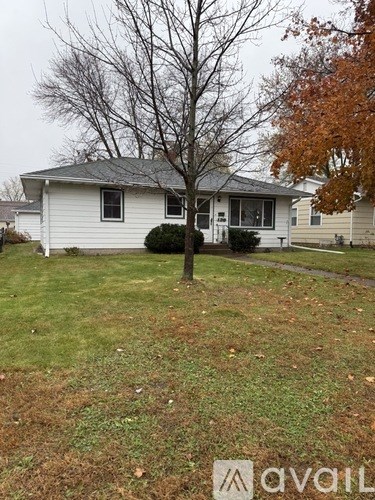 A house with a tree in front of it.