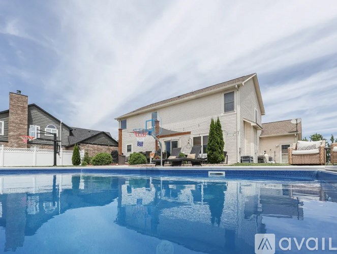 A house with a pool in front of it is for sale.