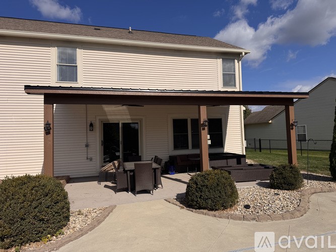 A house with a covered patio and a small garden.