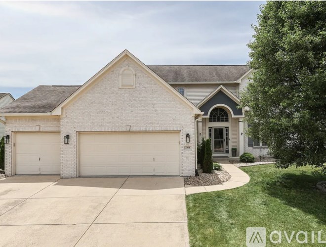 A house with a white garage door is for sale.