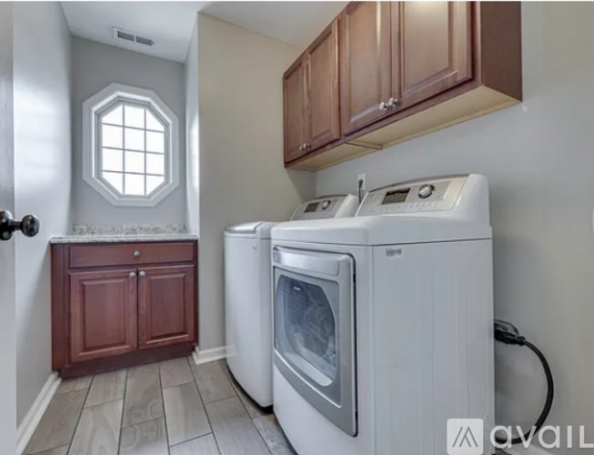 A small laundry room with a washer and dryer.