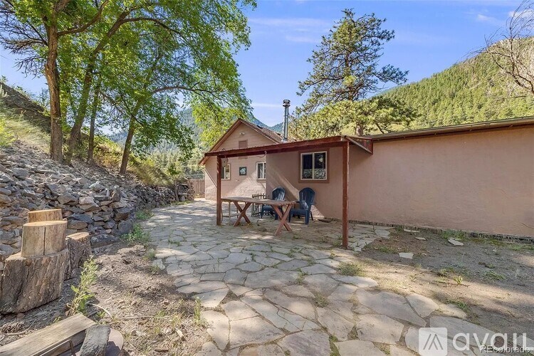 A small house with a stone pathway leading to it.