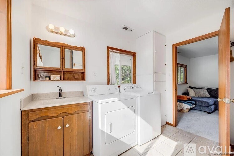 A small laundry room with a washer and dryer.