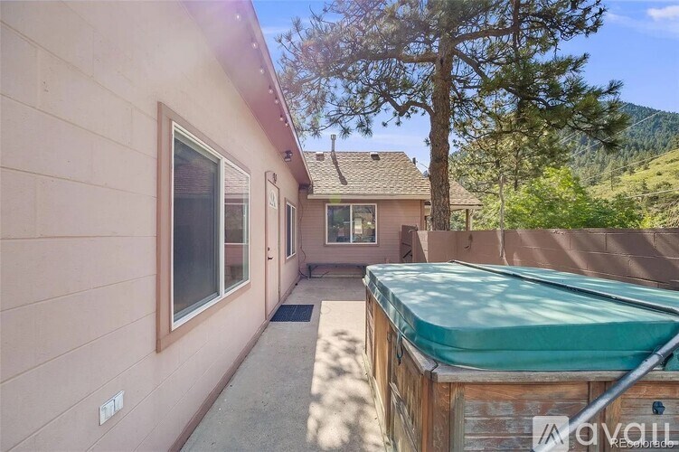 A house with a hot tub in the backyard.