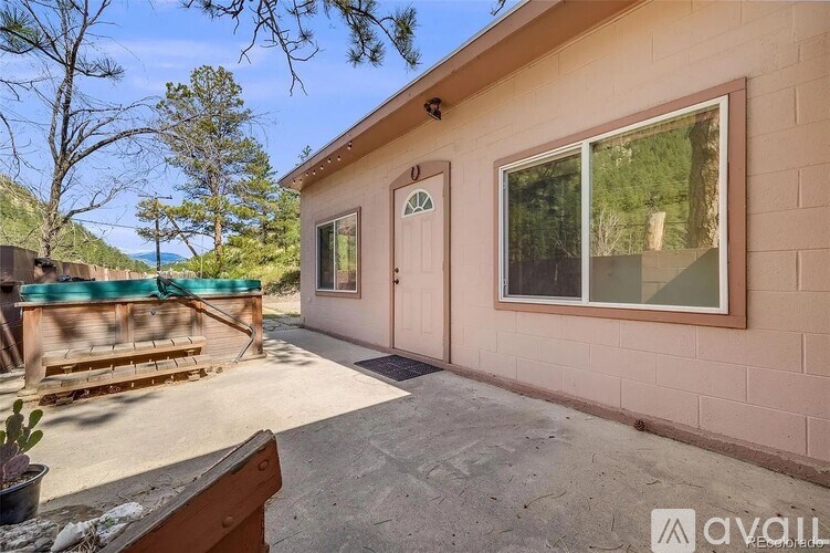 A house with a brown door and a window is for sale.