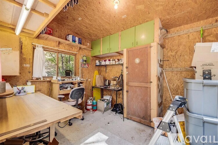 A room under construction with a table, chairs, and various tools.