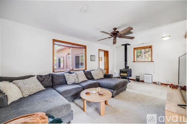 A living room with a grey couch and a wooden coffee table.