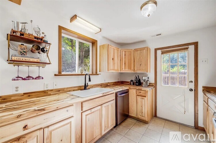 A kitchen with wooden cabinets and a white sink.