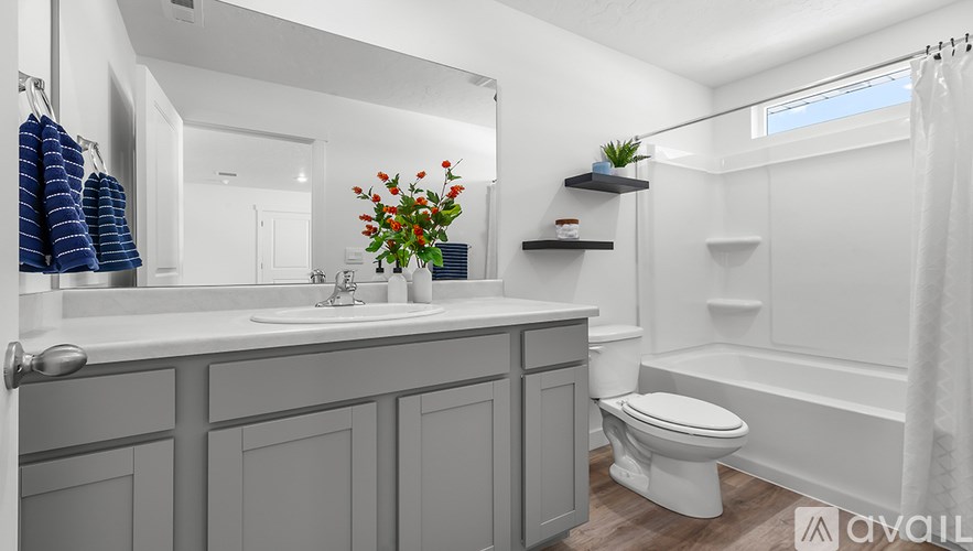 A bathroom with a white toilet, sink, and bathtub.