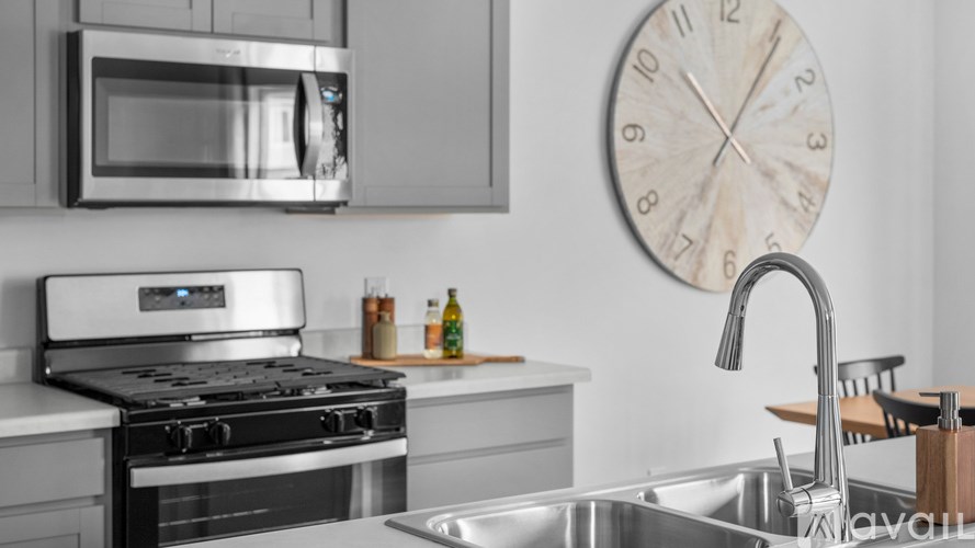 A modern kitchen with a stainless steel oven and microwave.
