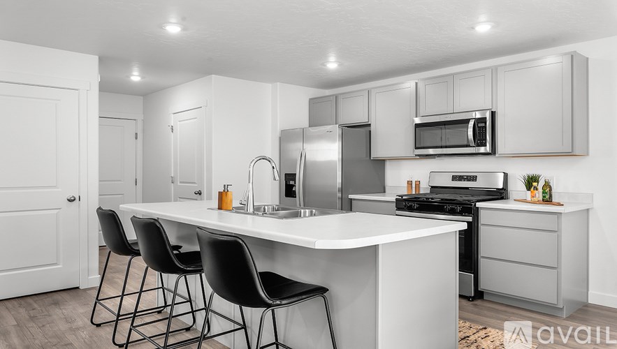 A modern kitchen with white cabinets and a central island.