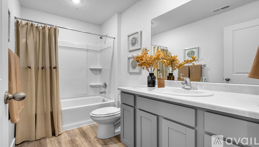 A bathroom with a toilet, sink, and shower.