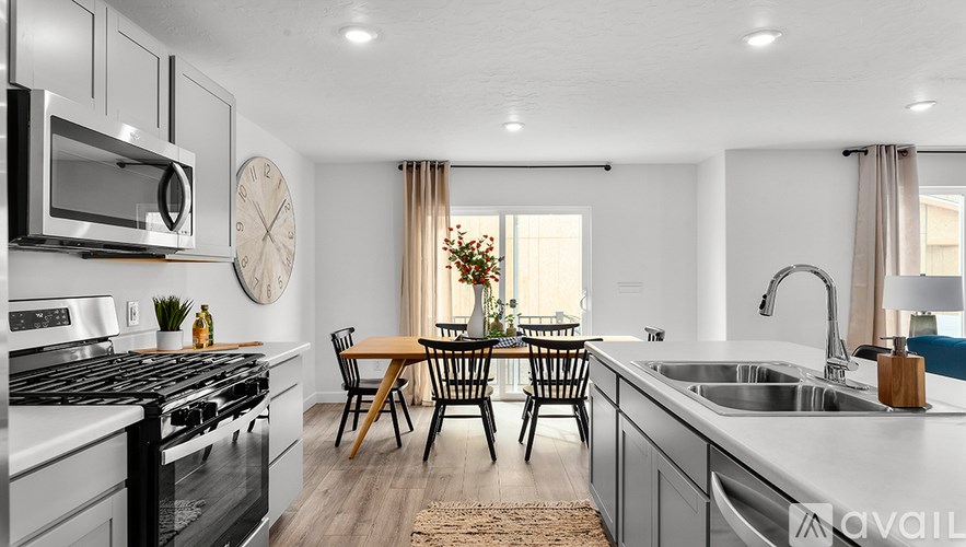A modern kitchen with a dining table set for four.