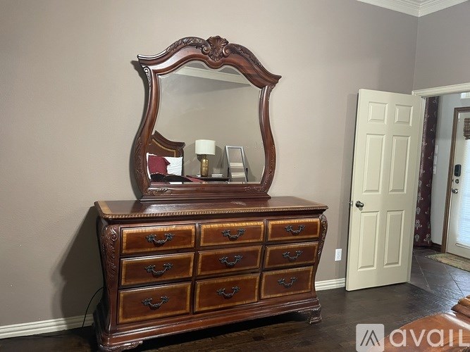 A wooden chest of drawers with a mirror on top is available for purchase.