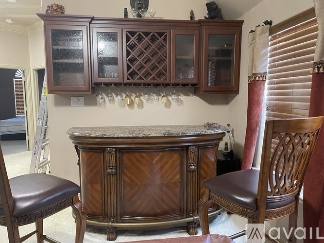 A brown wooden cabinet with glass doors and a countertop is in the foreground.