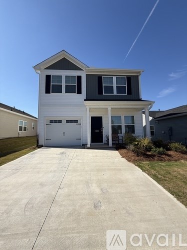 A two-story house with a garage is available for rent.