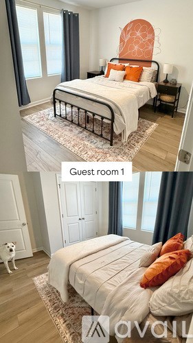 A guest room with a bed, a dog, and a window.