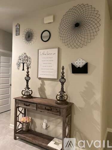 A wall with a decorative item and a sign.