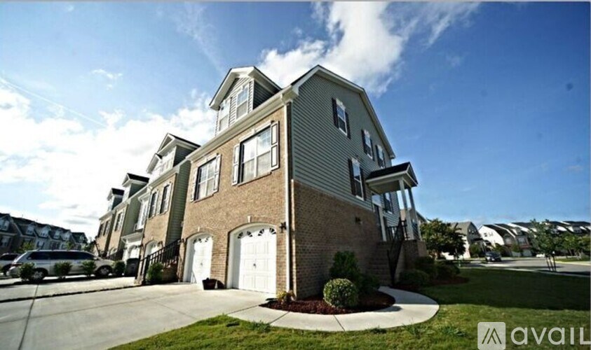 A modern two-story house with a garage is for sale.