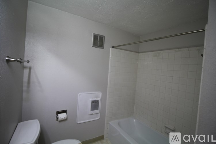 A bathroom with a toilet, sink, and shower.