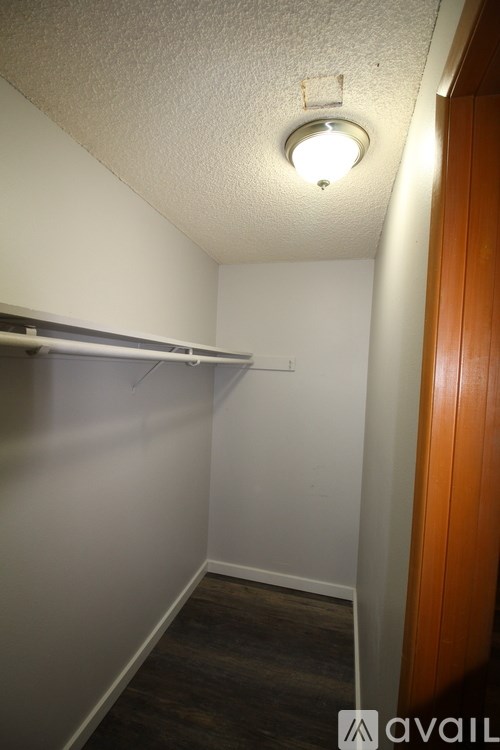 A small, empty room with a light on the ceiling.