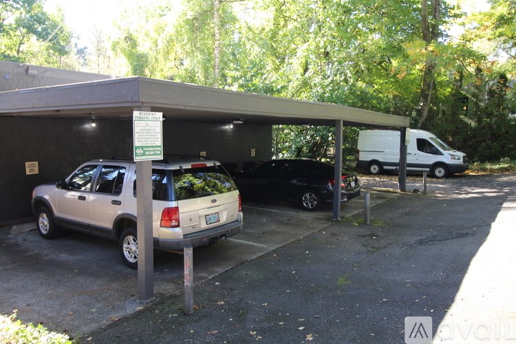 A parking garage with a sign and a van parked in it.