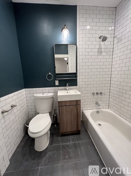 A bathroom with a white toilet, a sink, and a bathtub.