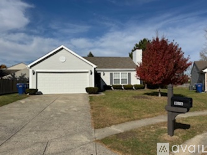 A house with a driveway and a mailbox in front.