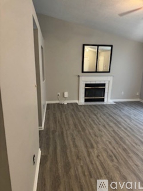 A room with a fireplace and a window.