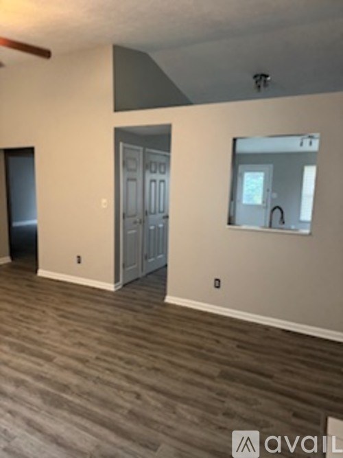 A room with a grey floor and a white door.