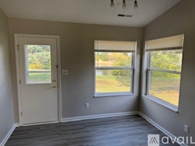 A room with a door and two windows.